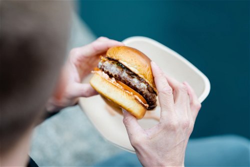 Stefan Jäckel's Storchen Beef Burger mit Beefsteak, Bergkäse, BBQ Sauce, Zwiebelconfit, Coleslaw, Tomate und Gurke