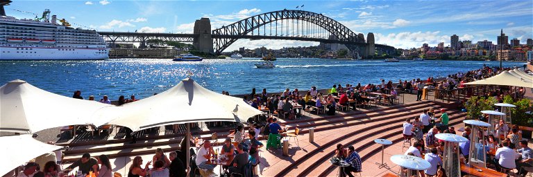 Diners relaxing next to Sydney harbour.