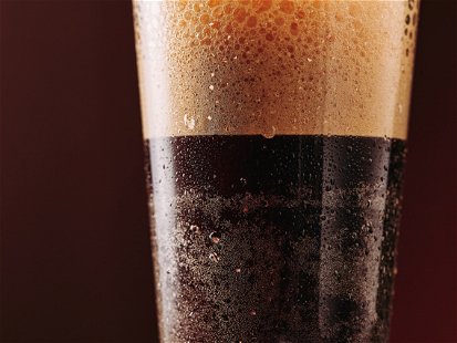Close up of cold brew nitro coffee. Lot of texture and drops. Macro shot. Poster with copy space.