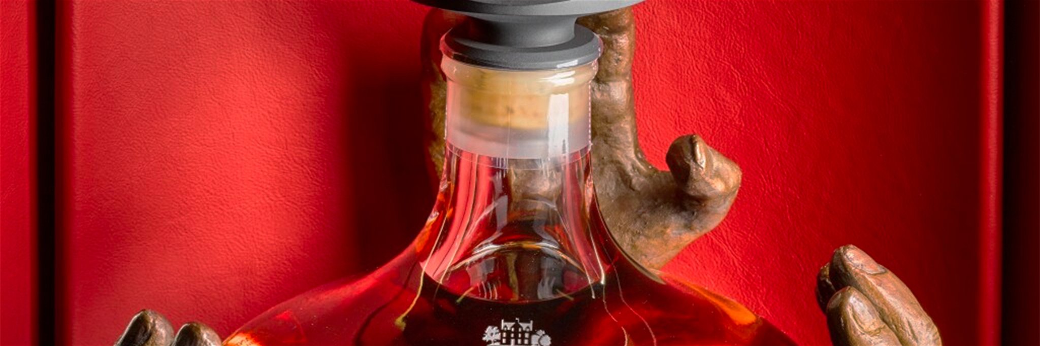 The bottle is encased in a mouth-blown decanter.