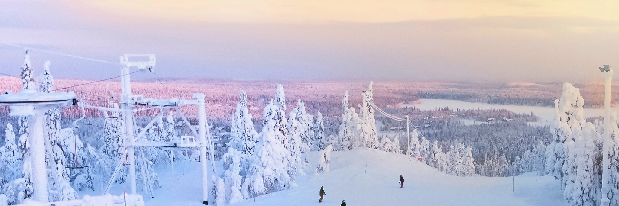 Sunrise over the snow-covered forest at Ruka, Finland.
