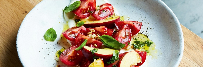 Tomato &amp; Peach Salad on a bed of cream cheese with a basil vinaigrette