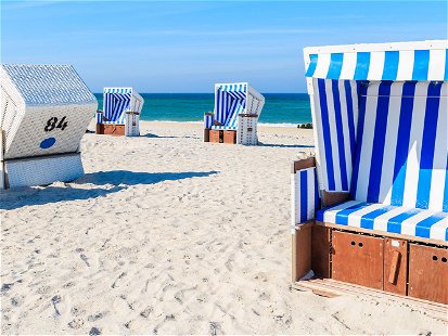 Wicker chairs on white sand Kampen beach, Sylt island, North Sea, Germany