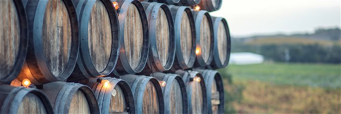 Oak barrels near a vineyard in California.