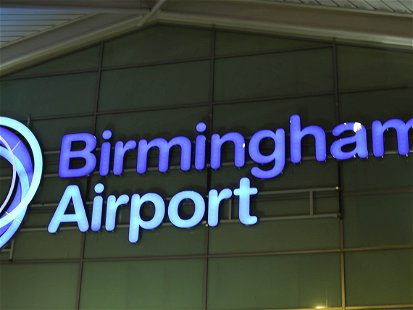Birmingham Airport, England - September 2017: Illuminated sign on the terminal building at night