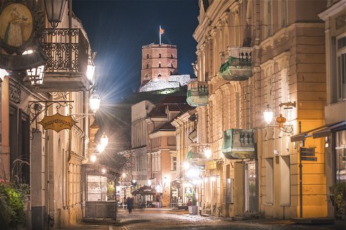 Piles street and Gediminas tower at night.