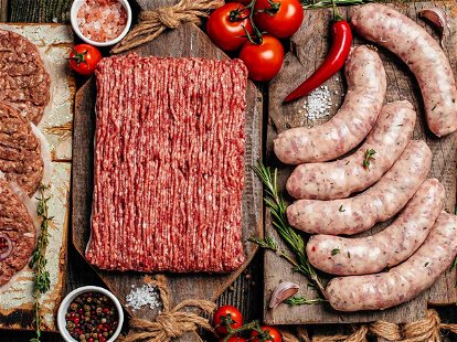 Various kinds of grill and bbq raw meats. Chicken, steak, sausages, minced beef meat kebabs, pork with herbs, spices on wooden background. Long banner format. top view.