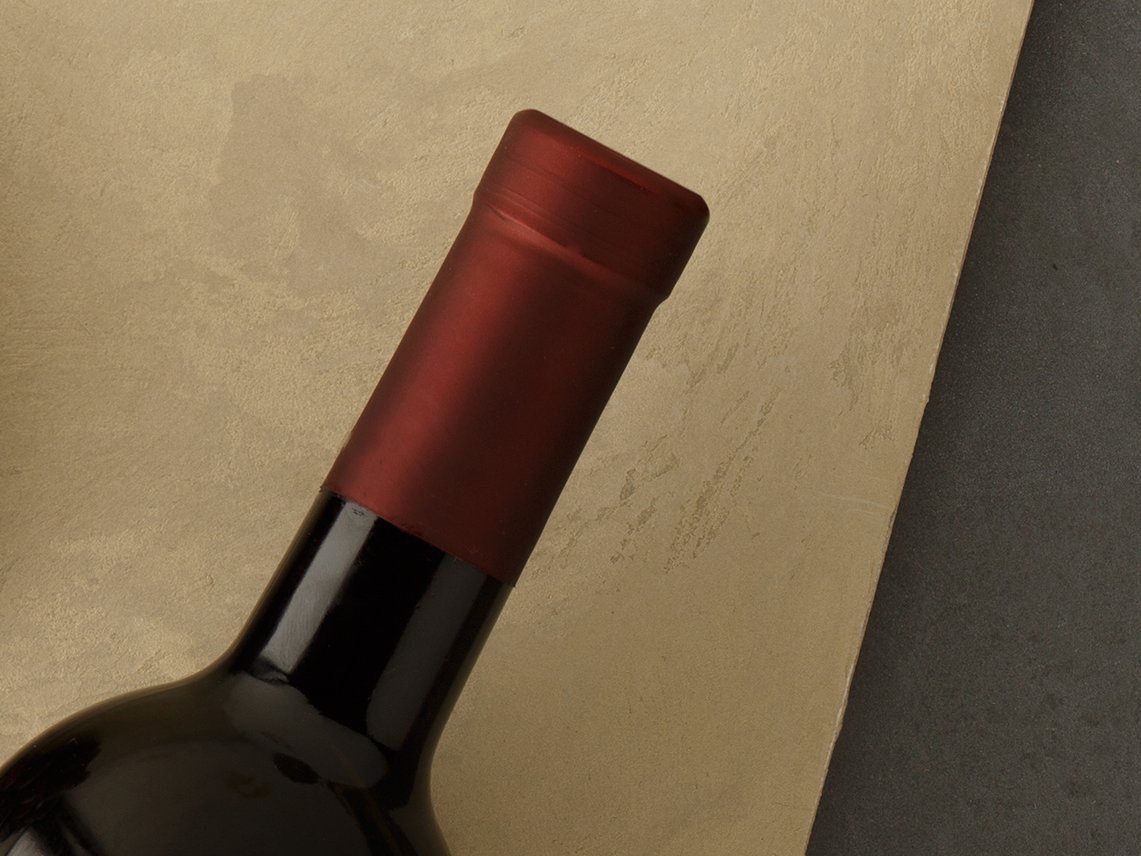Bottle of red wine with label. Glass of wine and cork. Wine bottle mockup. Top view.