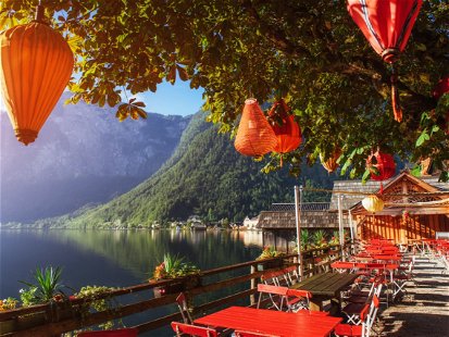 Summer cafe on the beautiful lake between mountains. Alps. Hallstatt. Austria