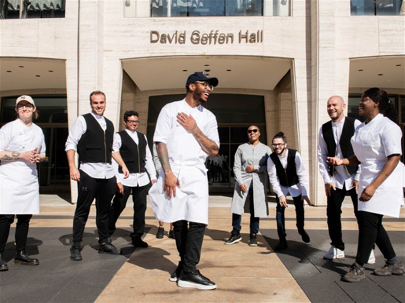 Kwame Onwuachi with his team in front of Lincoln Center on the Upper West Side, home of the New York Philharmonic. This is also the location of "Tatiana", Onwuachi's current restaurant.