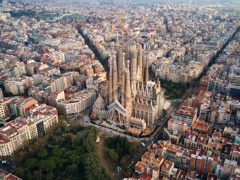 Aerial drone view of Barcelona, Spain. Blocks with multiple residential buildings and Sagrada Familia