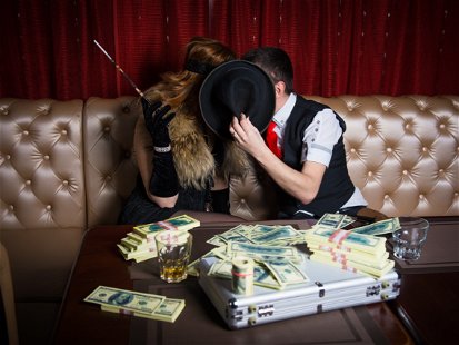 money on the table, a man and a woman kissing a hat closing face