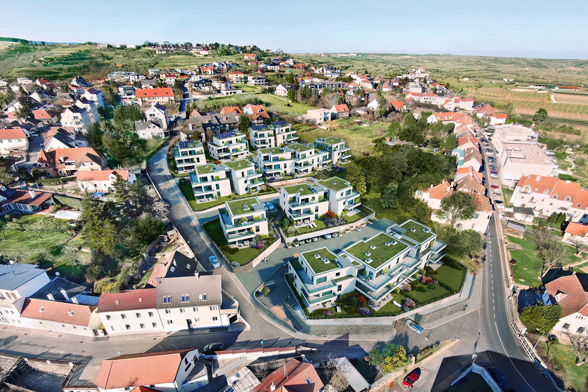 Kraxenweg von oben: Die Weingartensiedlung ist in eine rundum kleinmaßstäbliche Wohnbebauung eingebettet. Und irgendwo dort hinten, weit hinter den Hügeln, liegen Gneixendorf und Langenlois.